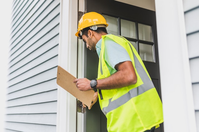 a property inspector looking at the front door